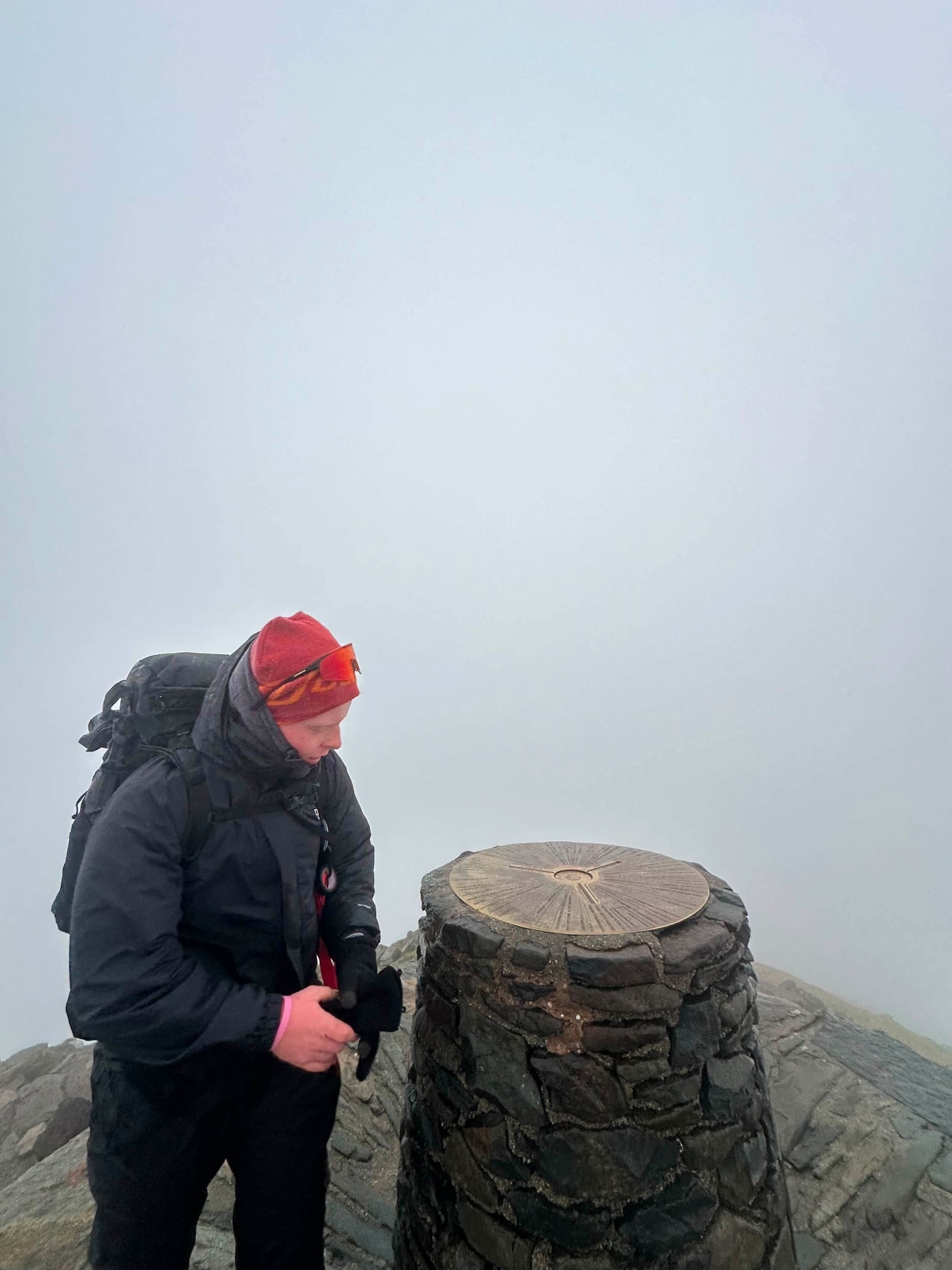 Sam at a misty mountain trig point